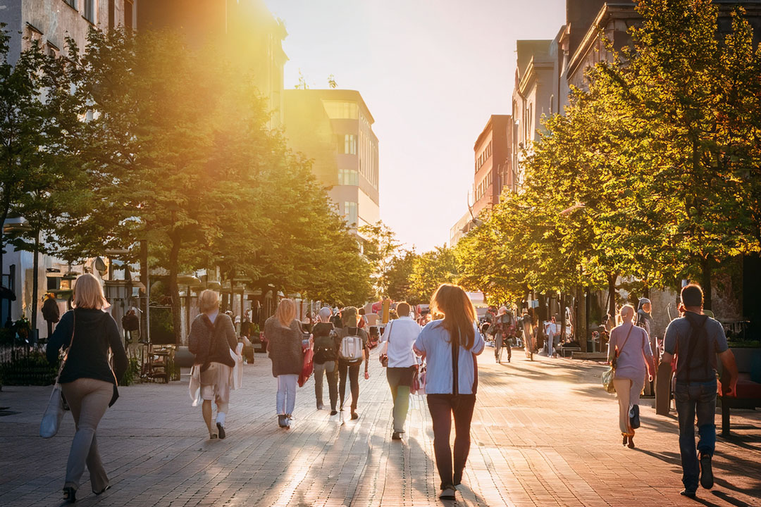 People walking on a nice day in a local community.