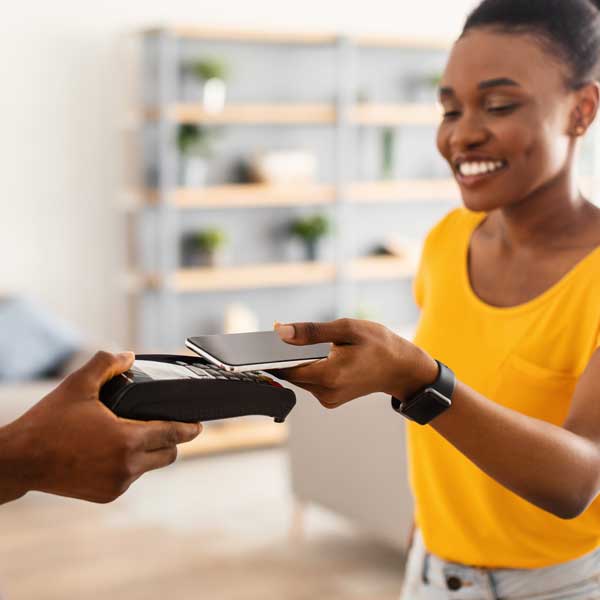 woman-yellow-shirt-tapping-payment-device